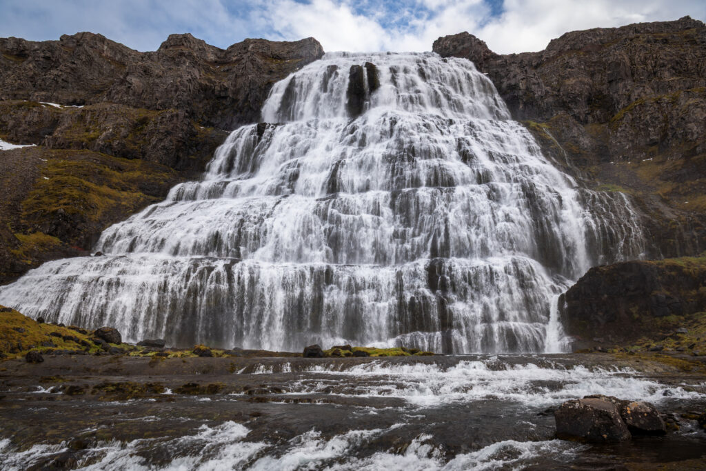 Dynjandi waterfall in the Westfjords, Iceland — the tiered cascade drops 100 metres and widens toward the base, one of Iceland's most dramatic waterfalls