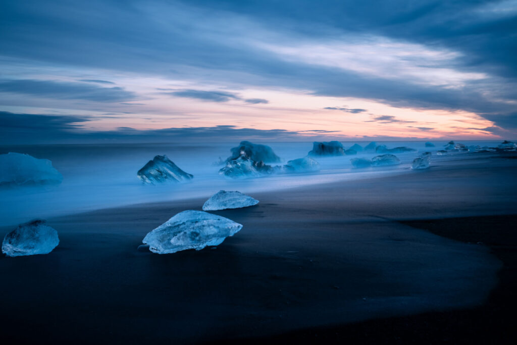 Long exposure of glacial ice on Diamond Beach at blue hour, south Iceland — photographed by Marcel Strobel