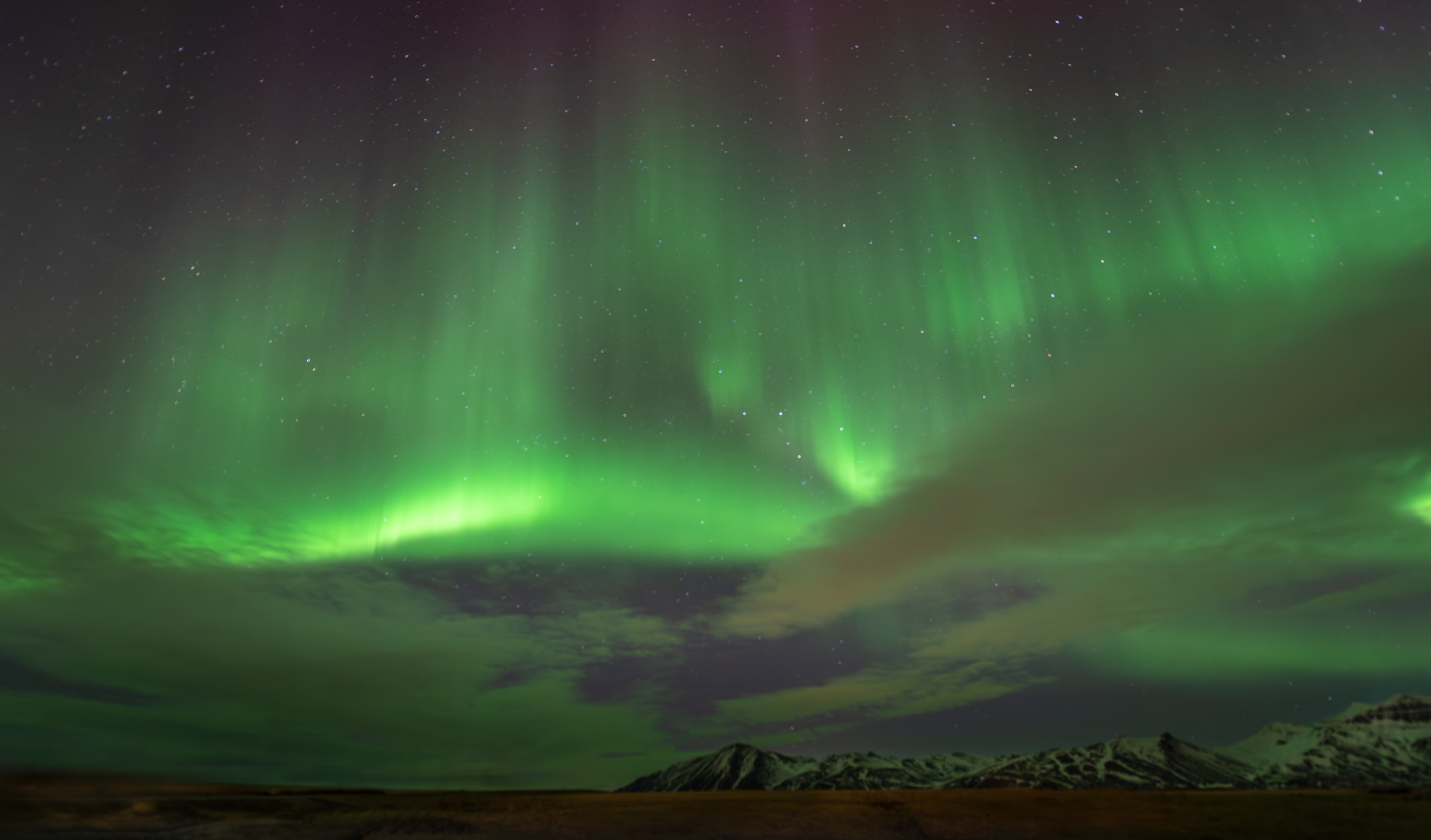 Northern Lights over the mountains near Hótel Laxárbakki, northwest Iceland — photographed by Marcel Strobel