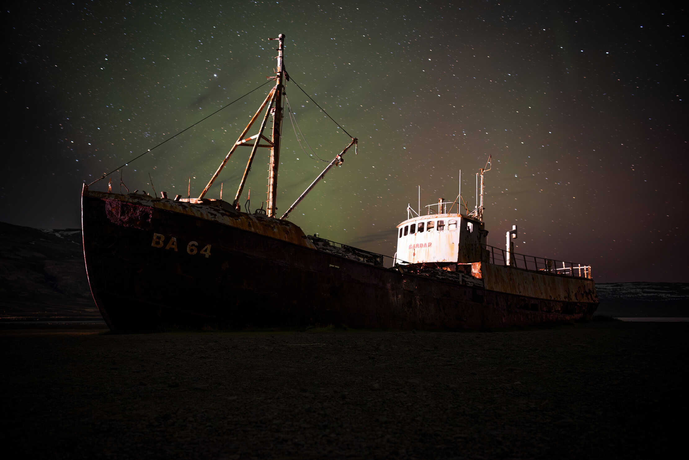 Garðar BA 64 shipwreck under the Northern Lights, Patreksfjörður, Westfjords, Iceland — photographed by Marcel Strobel
