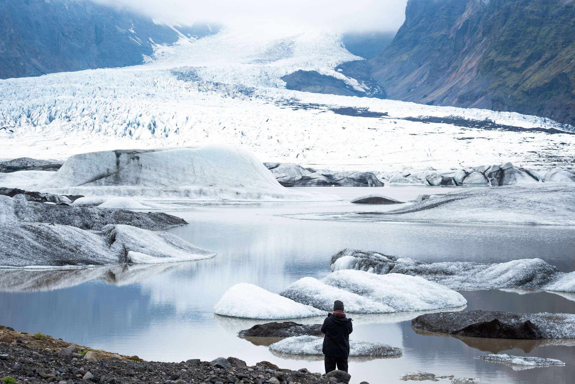 Photographer standing before Kvíárjökull glacier tongue, south Iceland — photographed by Marcel Strobel