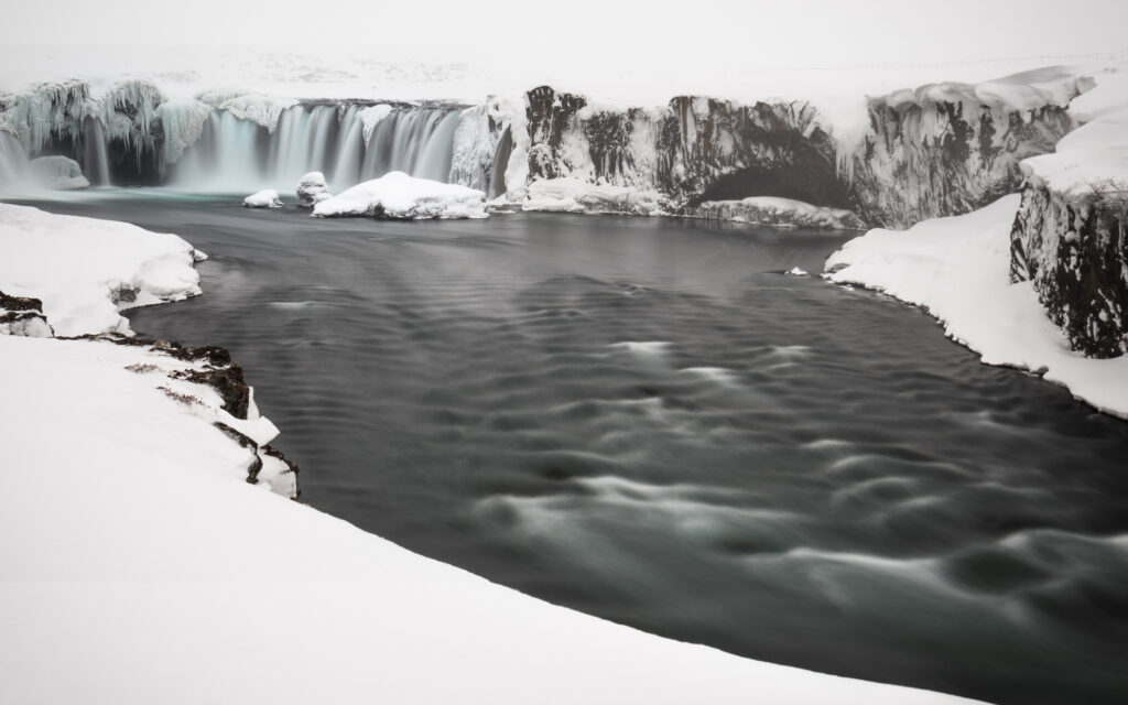Goðafoss waterfall in winter with snow and ice formations, north Iceland — photographed by Marcel Strobel