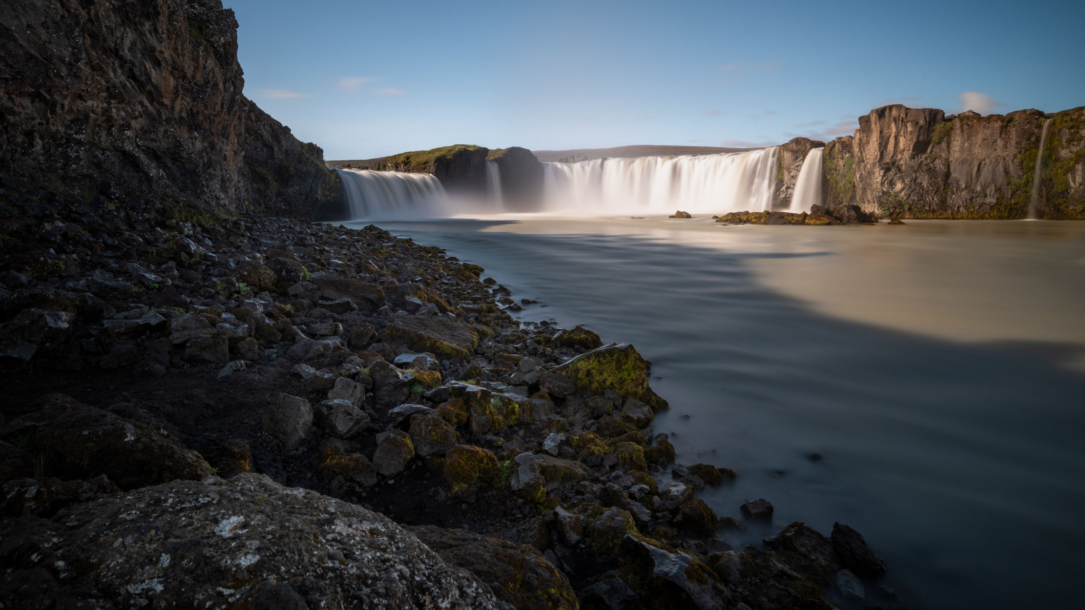 Goðafoss waterfall from the riverbank below, long exposure, north Iceland — photographed by Marcel Strobel