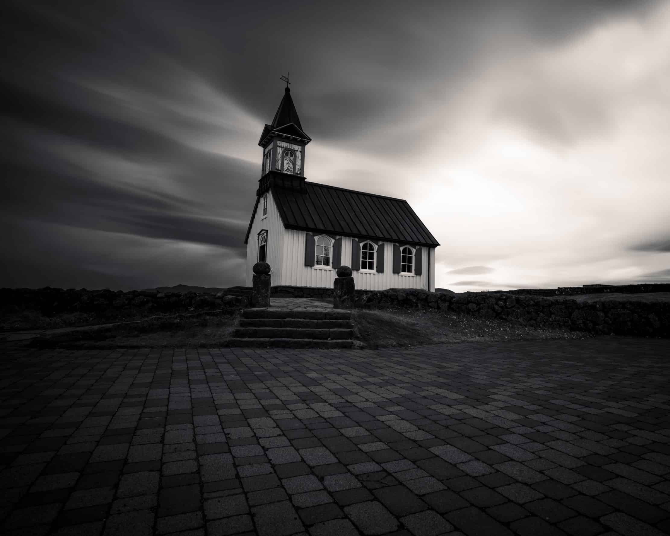 Þingvallakirkja church under a dramatic sky, Þingvellir National Park, Iceland — long exposure photography by Marcel Strobel