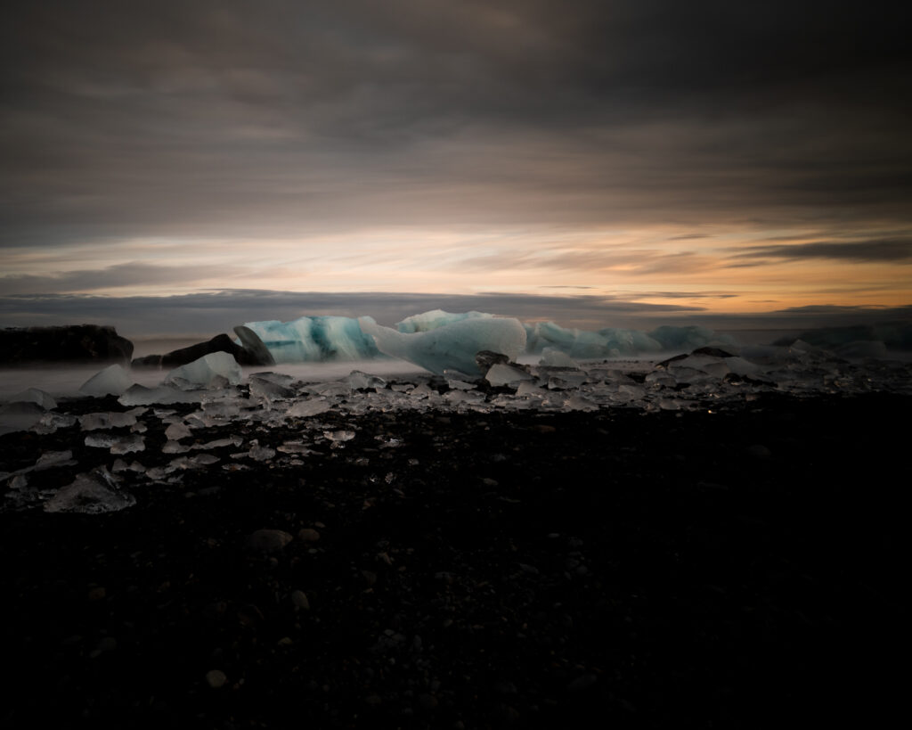 Dramatic sunset over Jökulsárlón glacier lagoon with icebergs and Vatnajökull glacier, Iceland — photographed by Marcel Strobel
